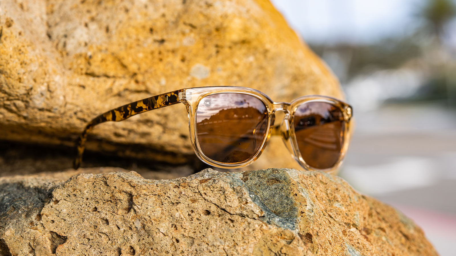 Sunglasses with Glossy translucent amber fronts Matte tortoise shell arms Polarized amber lenses
