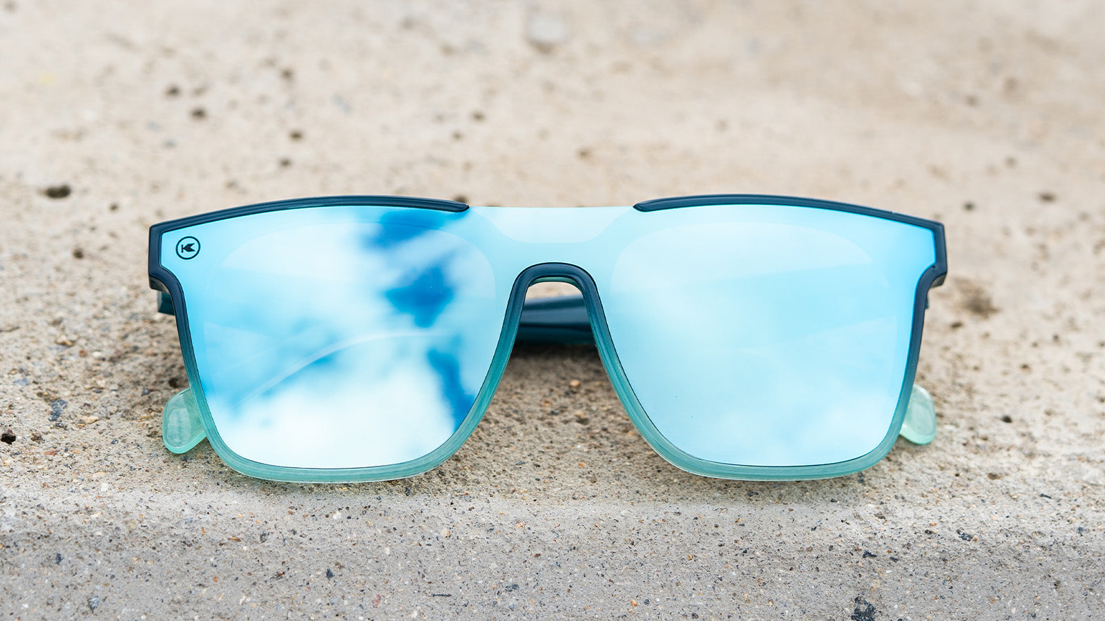 Sunglasses with a blue frame with polarized blue lenses, flyover