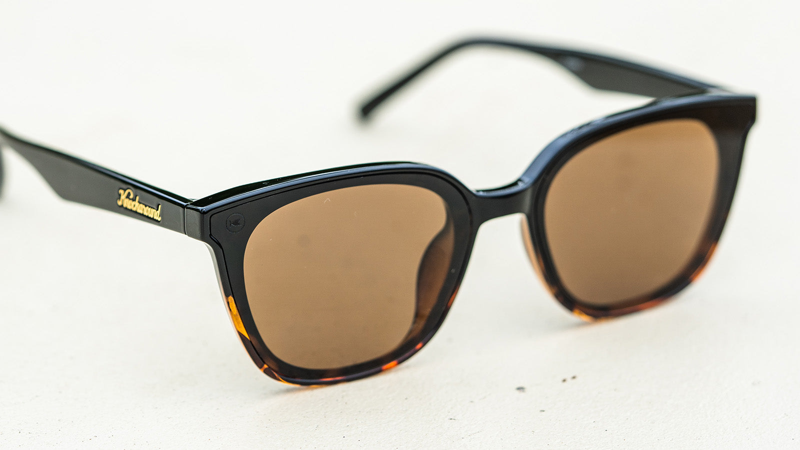Sunglasses with a amber frame with polarized amber lenses, flyover