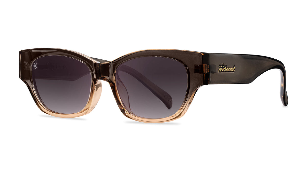 Sunglasses with a glossy muted-gray-to-peach frame and polarized smoke gradient lenses, Threequarter