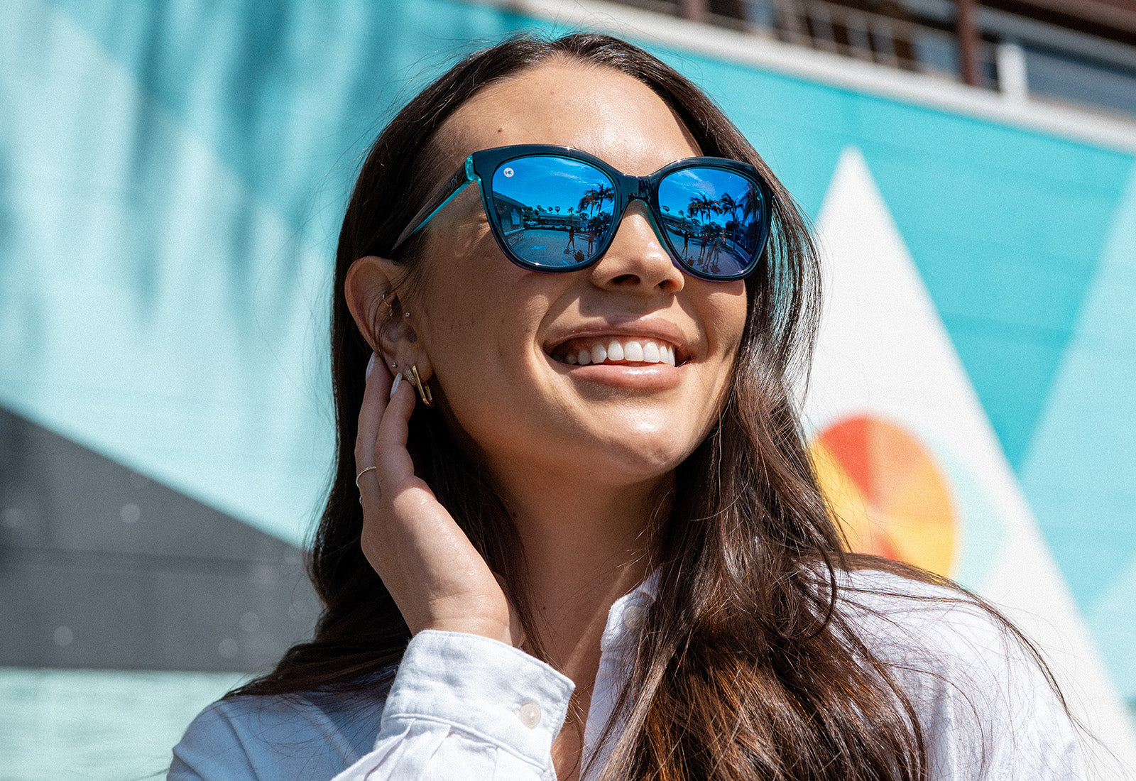 Sunglasses with Glossy Black Exterior and Ice Blue to Lavender Interior and Polarized Snow Opal Lenses. Flyover
